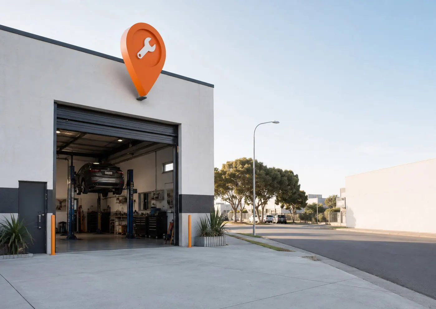 Workshop building with a giant orange map pin on the roof